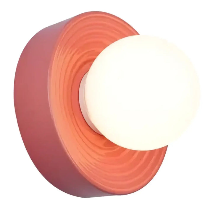 Coral-colored applique alicia wall sconce with frosted glass globe for elegant indoor lighting