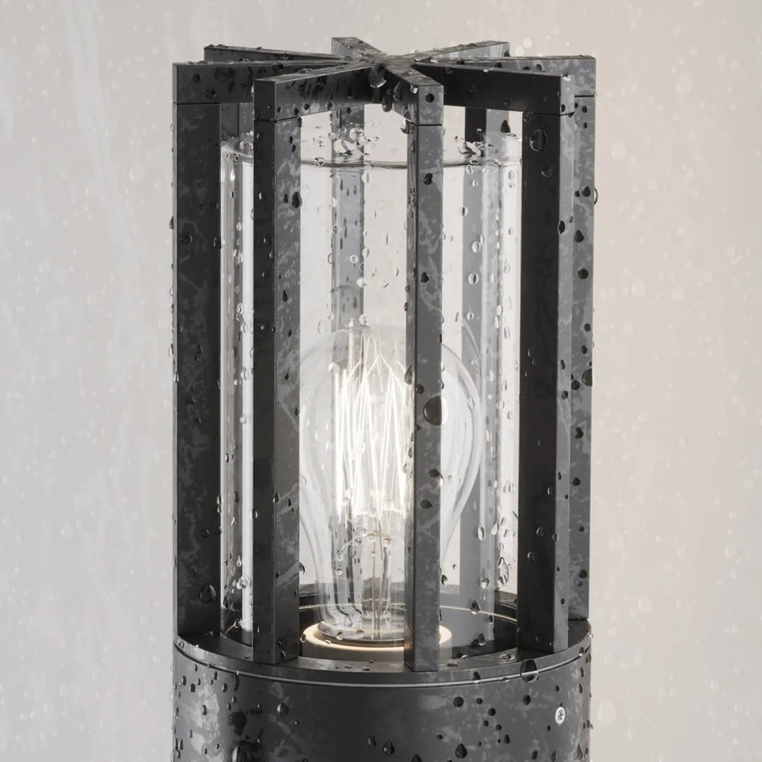 Applique extérieure barrel en métal graphite avec verre transparent et ampoule à filament visible dans une lanterne noire