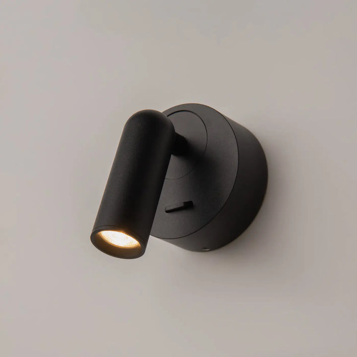 Applique liseuse mirror x module rond noir mat avec tête réglable émettant une lumière chaude