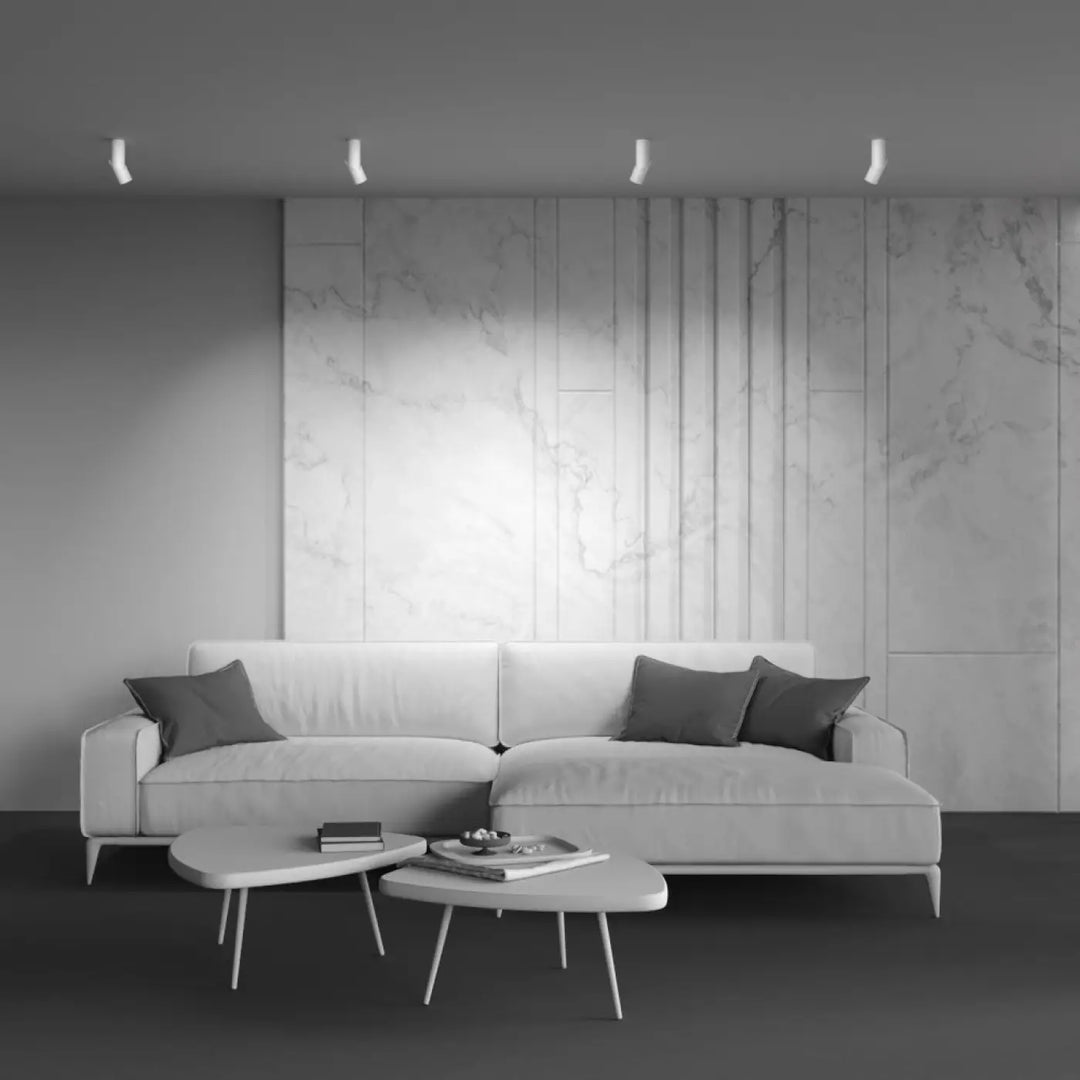 Applique murale profil plié en acier noir avec canapé dangle blanc et coussins gris foncé design minimaliste