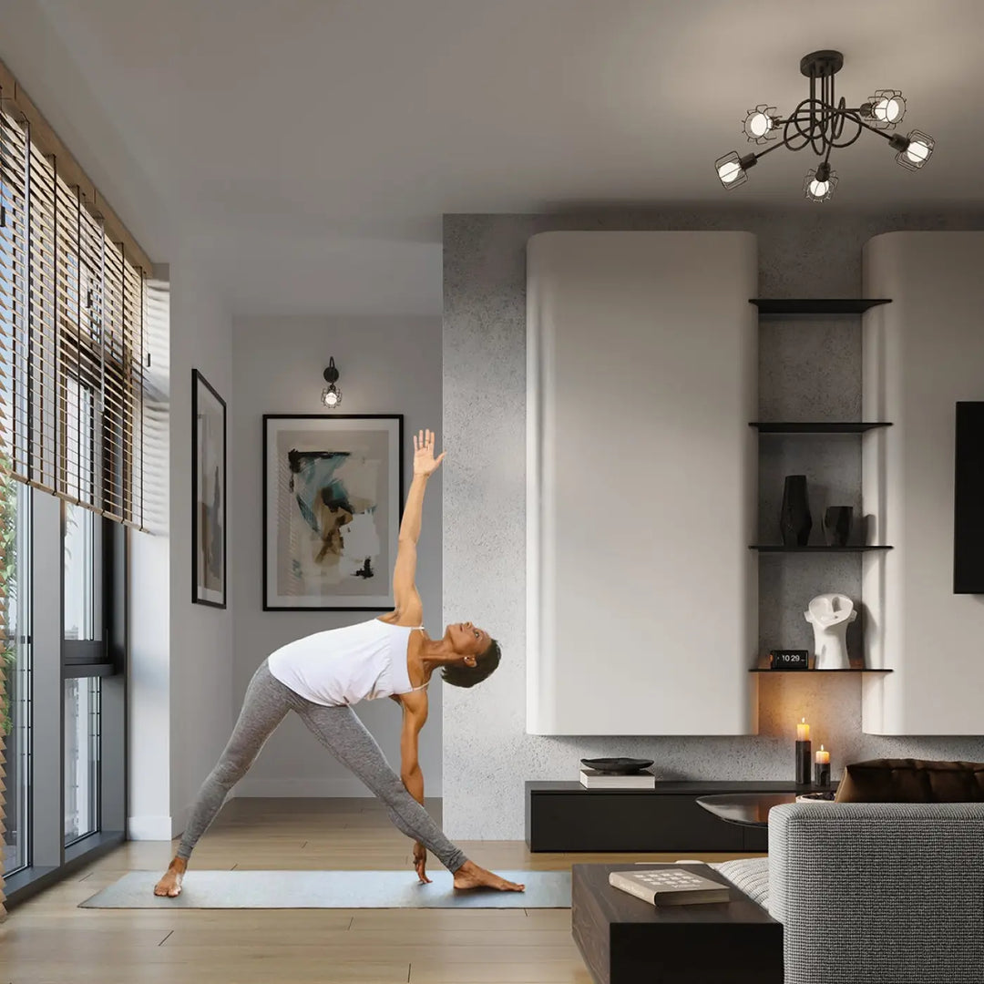Une femme en débardeur blanc et leggings gris pratique le yoga sur un tapis bleu clair près d une applique murale beluci 1s noir style loft collection beluci