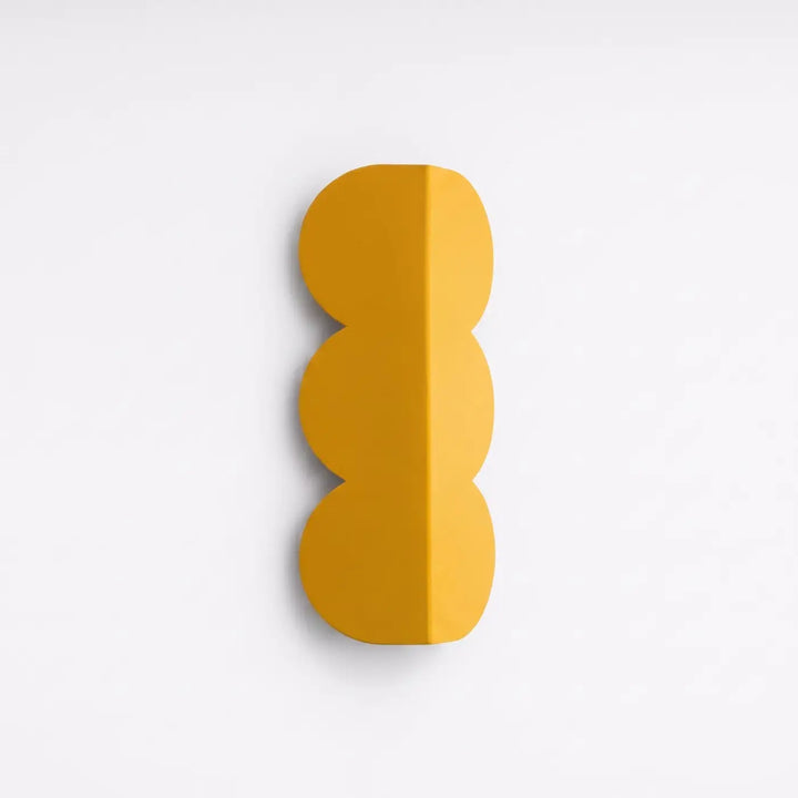 Applique murale BISCUIT jaune éteinte, posée au mur