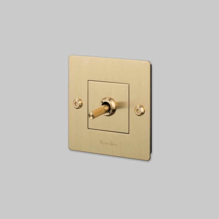 Interrupteur à levier Toggle à gravure alignée avec logo doré, finition laiton #couleur_dor