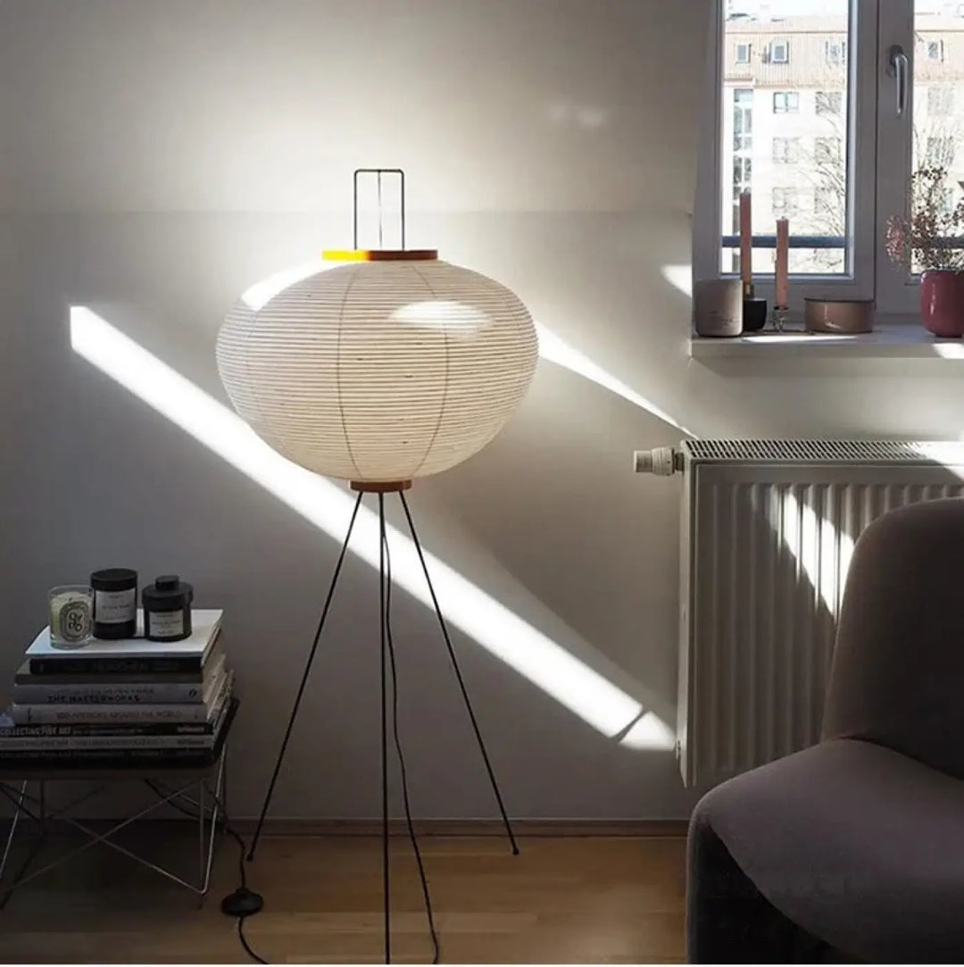 Lampadaire chloe avec base tripode noire et abat-jour sphérique en papier blanc design élégant plus qu’un simple luminaire