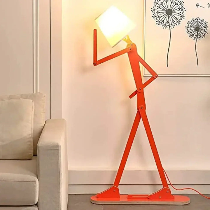 Lampadaire fer type orange avec abat-jour carré blanc et bras articulés en métal formant une silhouette debout