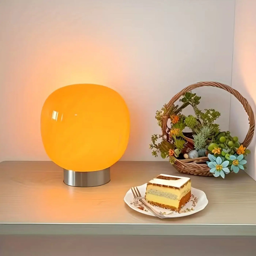 Lampe de chevet macaron avec lampe orange chaude sphérique et base métallique élégante pour décoration intérieure minimaliste