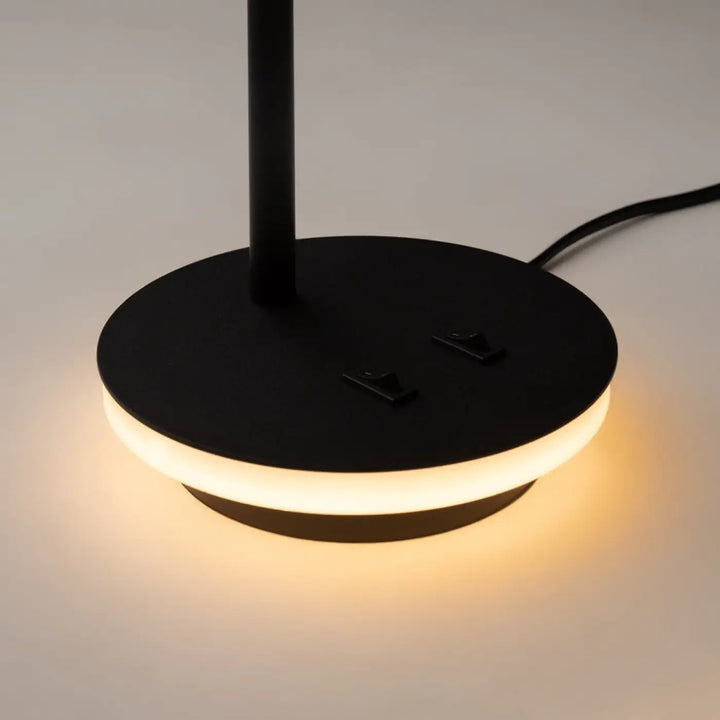 Lampe à poser noire ronde avec rétroéclairage décoratif et liseuse led pour une ambiance chaleureuse moderne