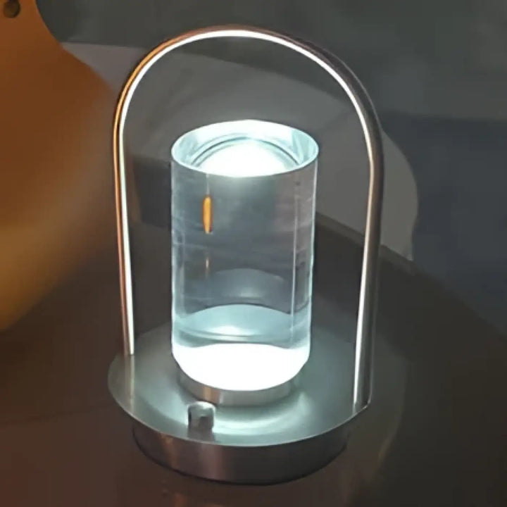 Lampe de table neora avec arche épurée en métal et lumière cylindrique flottante en verre clair pour un design moderne