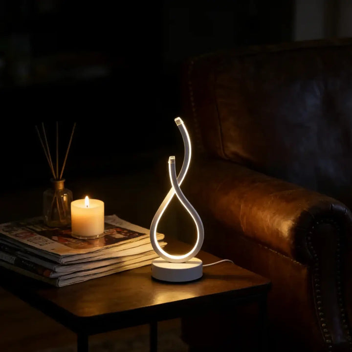 Lampe de table infinia avec boucle lumineuse blanche led en silhouette sculpturale moderne design élégant