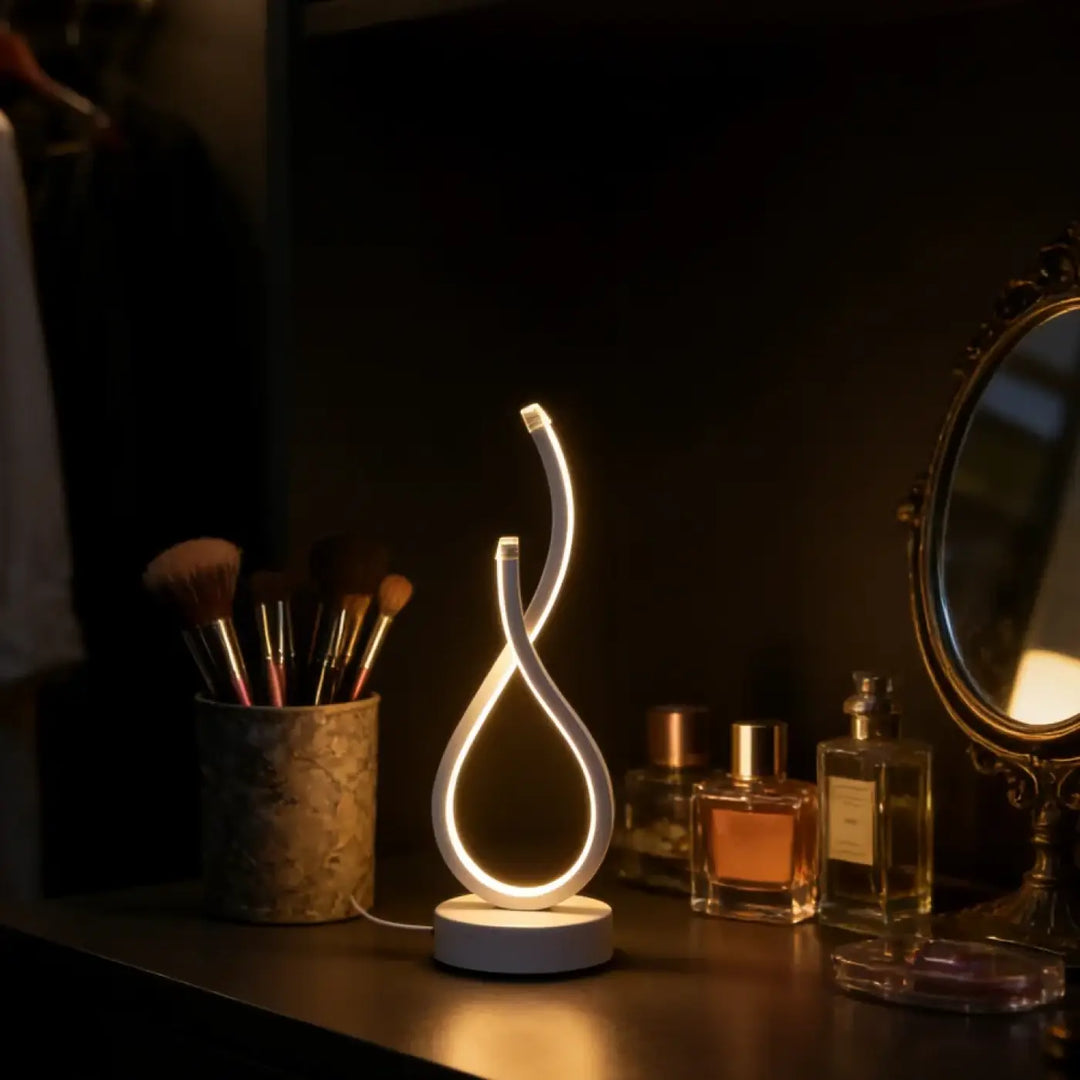 Lampe de table infinia avec boucle lumineuse led blanche et silhouette sculpturale moderne pour table design