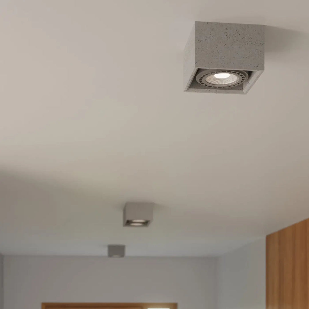 Luminaire plafonnier quatro 1 en béton avec finition grise texturée et ampoule led encastrée pour sentir mieux