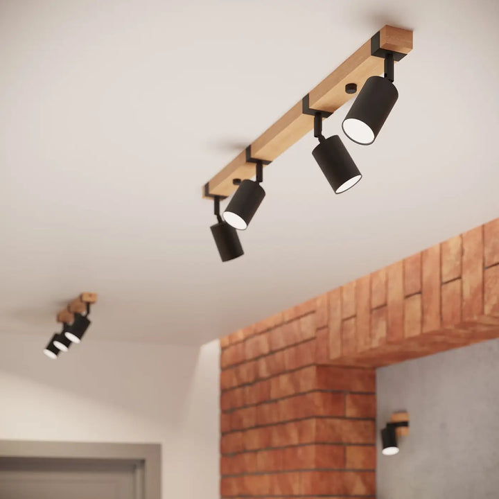 Lampe directionnelle fager noir avec abat-jours orientables montés sur un rail en bois naturel clair
