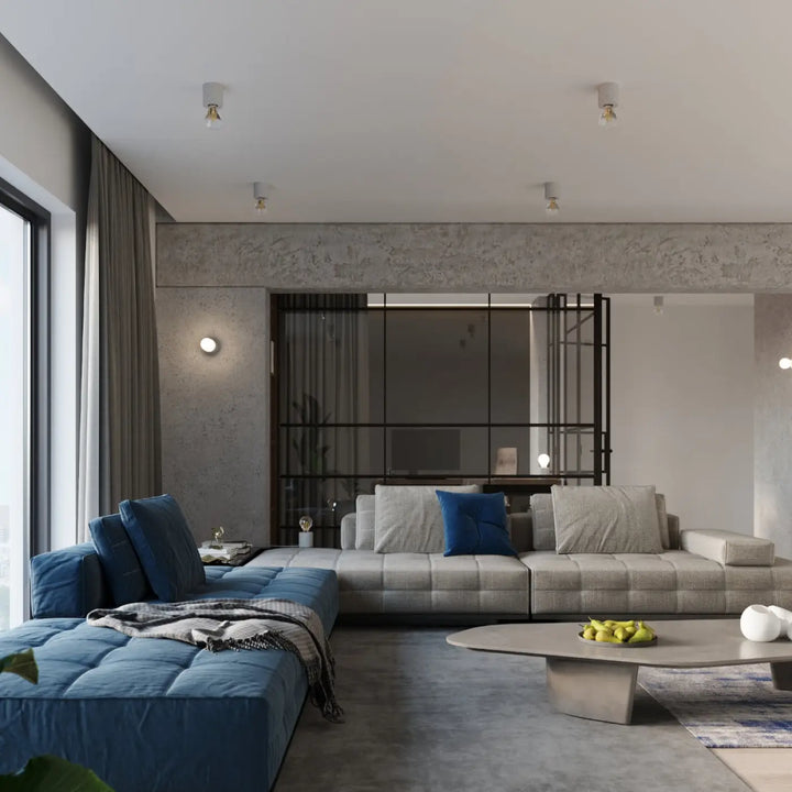 Sectionnel moderne plafonnier salgado en béton avec tissu gris clair et coussins bleu profond sentez mieux