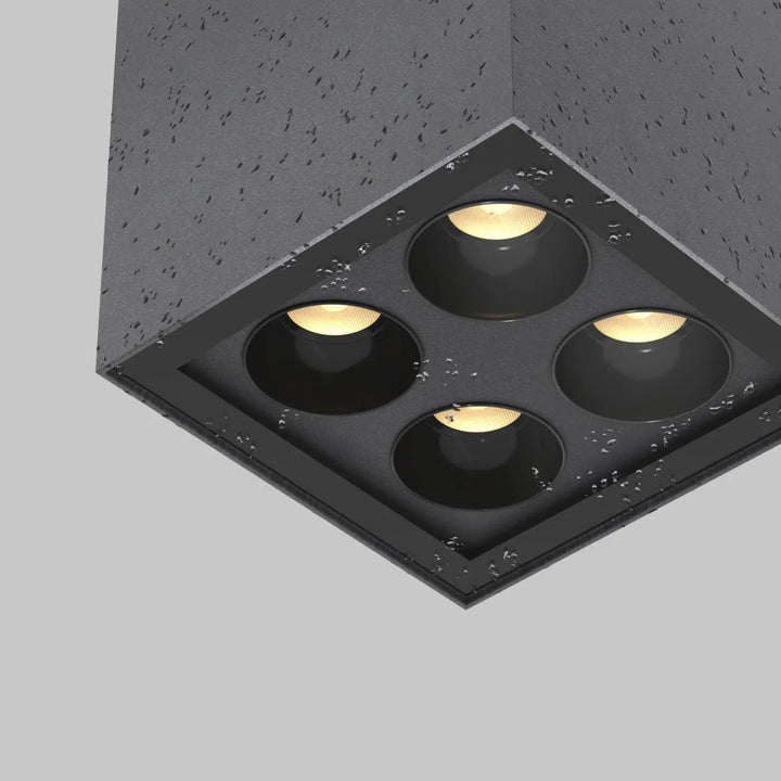 Plafonnier extérieur luminaire ares en métal graphite avec quatre led chaudes intégré dans un boîtier béton texturé