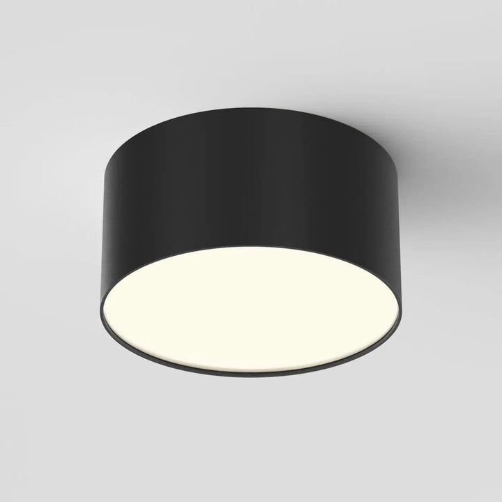 Plafonnier led zon noir cylindrique mat avec illumination blanche chaude profil fin et design rond minimaliste