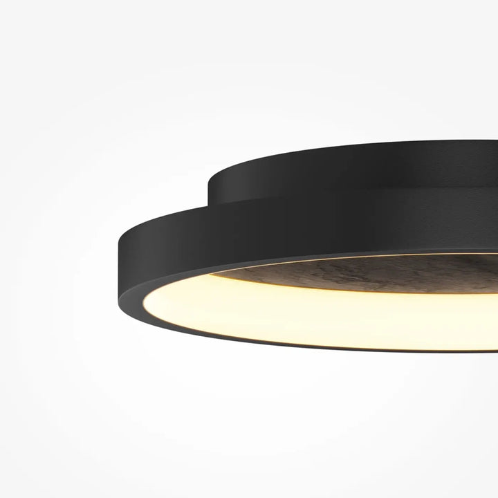 Luminaire plafonnier orign effet pierre noir avec anneau intérieur lumineux diffusant une lumière chaude moderne