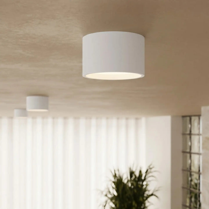 Plafonnier rond plat blanc allumé, vue rapprochée