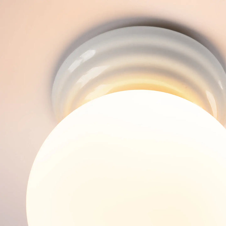 Plafonnier zori blanc avec globe en verre dépoli et base céramique striée pour une belle décoration aux qualités esthétiques