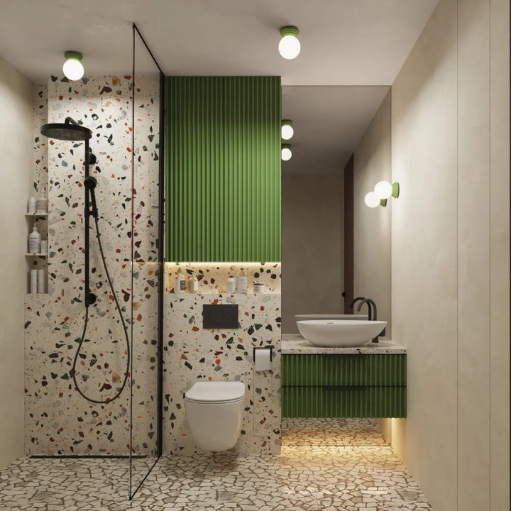 Plafonnier zori vert ip44 dans une salle de bain moderne avec murs et sol en terrazzo et meuble vasque vert à panneaux verticaux offrant une belle décoration aux qualités esthétiques
