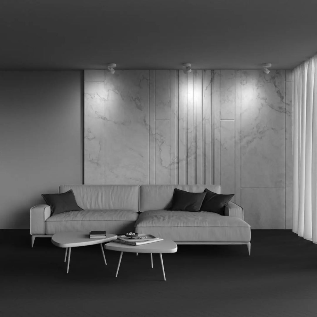Canapé dangle en cuir gris moderne avec coussins foncés présenté avec spot onda disque rétractable spot encastrable