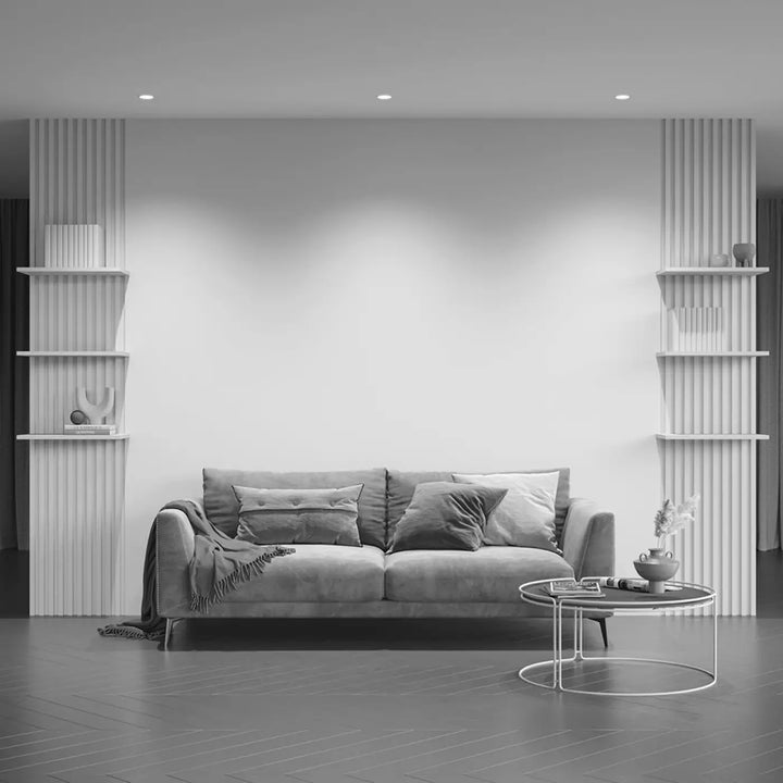 Canapé en velours gris avec coussins capitonnés et plaid drapé pour spot encastré avec enjoliveur noir culot gu10