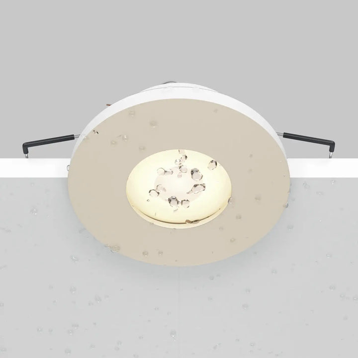 Spot Stark beige à faible profondeur avec panneau led doré et bras de fixation noirs pour spot encastré étanche