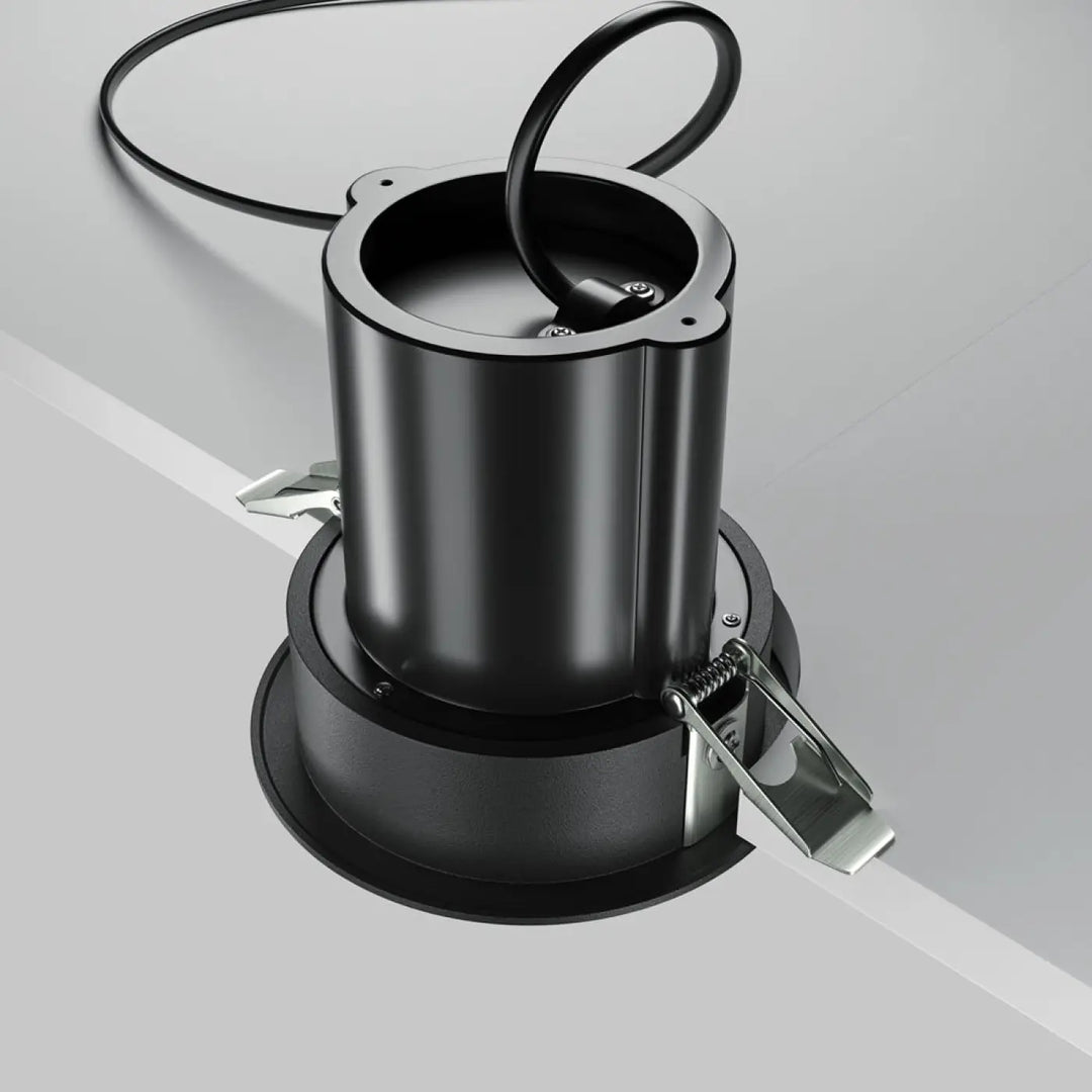 Spot hidden led rétractable en acier noir avec design moderne cylindrique et fixation visible au plafond encastré