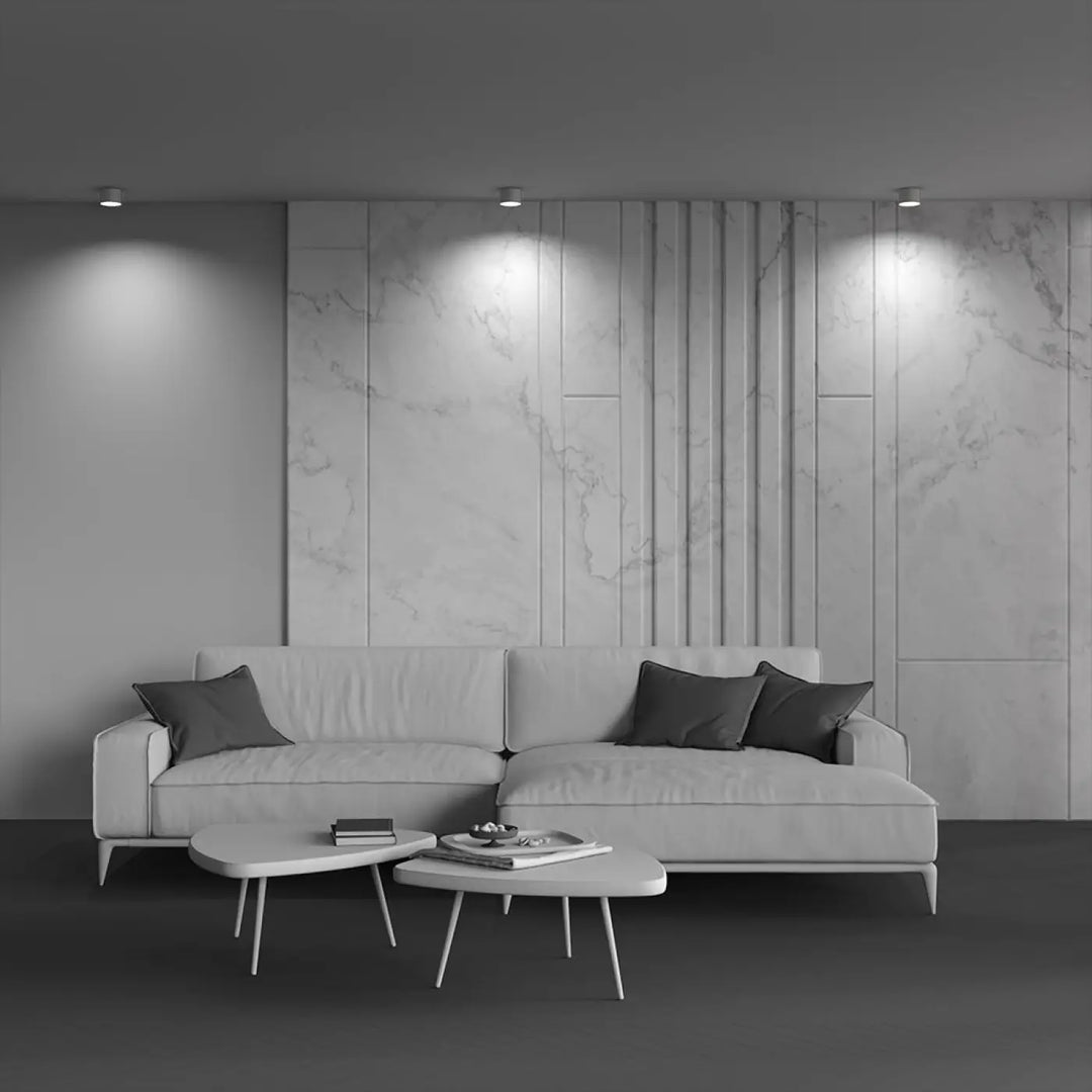 Canapé moderne minimaliste en cuir blanc avec coussins gris foncé et spot vega led intégrée pour intérieur élégant