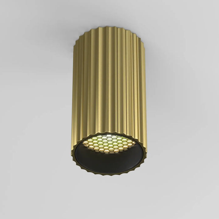 Spot calipso cylindre cannelé doré avec éclairage ciblé à led hexagonal base trois finitions