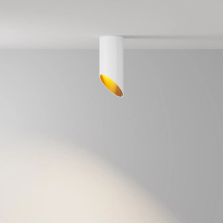 Spot lipari long cylindre en acier noir avec spot cylindrique blanc et intérieur doré pour éclairage design