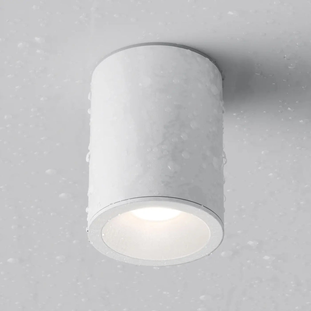 Spot zoom cylindre blanc avec finition mate et texture subtile pour lumière dirigée en faux plafond