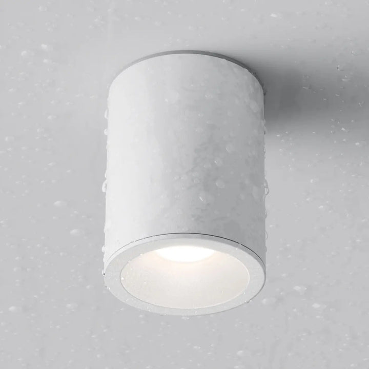 Spot zoom cylindre blanc avec finition mate et texture subtile pour lumière dirigée en faux plafond