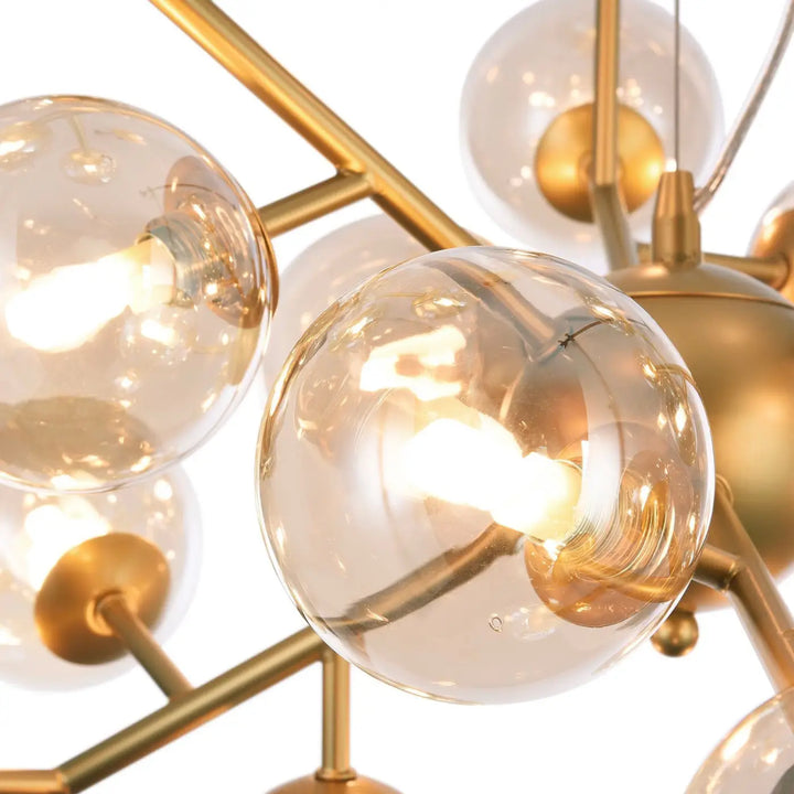 Suspension luminaire dallas en finition dorée avec globes en verre clair et ampoules à filament pour salle à manger