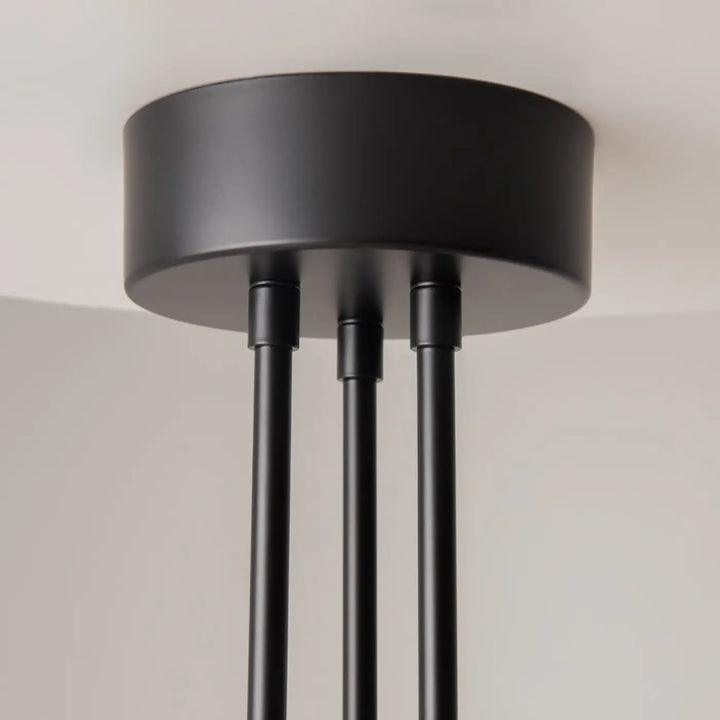 Suspension fad bras articulés en métal noir avec finition mate et trois tiges fines pour éclairage plafond moderne
