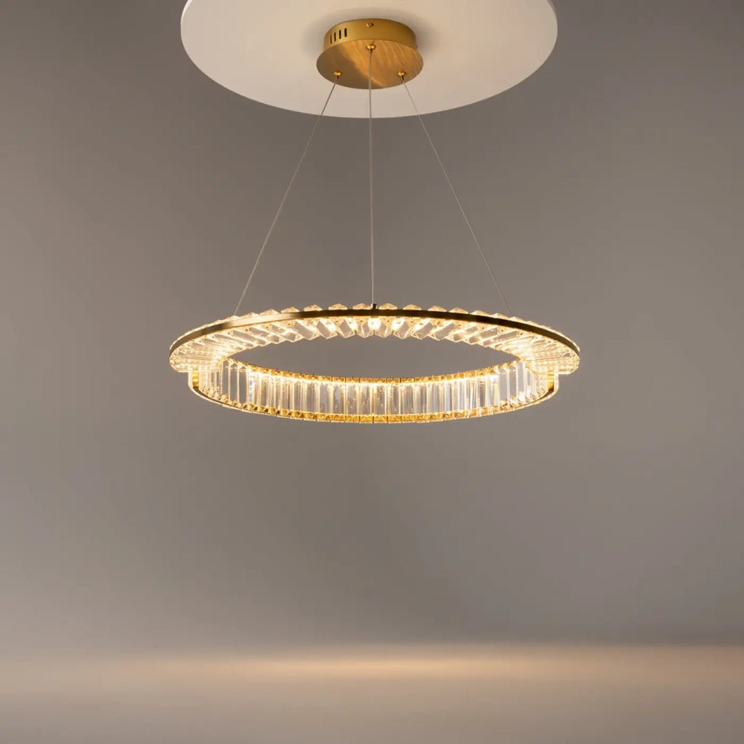 Suspension krone avec anneau doré serti en métal et tiges cristallines diffusant une lumière chaude