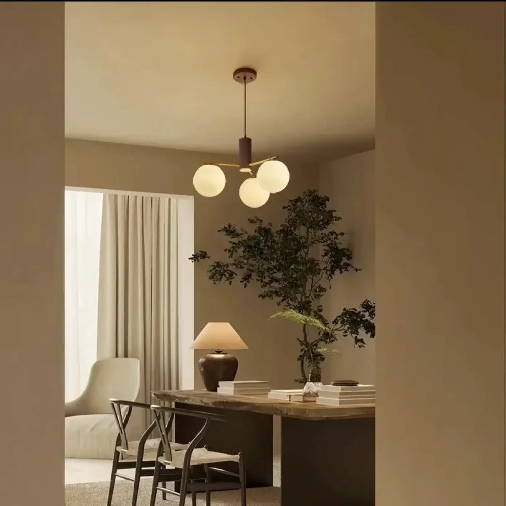 Suspension luminaire juglys avec trois sphères lumineuses en verre givré et finition bronze foncé moderne minimaliste