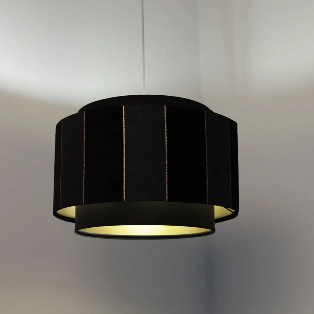 Suspension luminaire noir doblo cylindrique avec bordure dorée et lumière intérieure jaune chaud