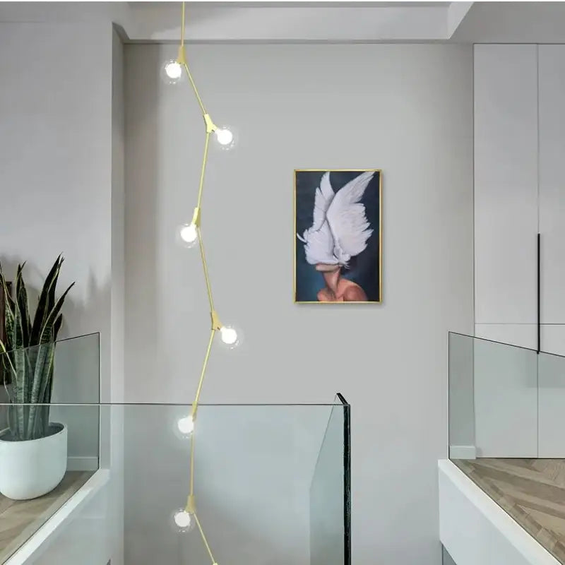 Suspension luminaire verticale en boules opales et laiton