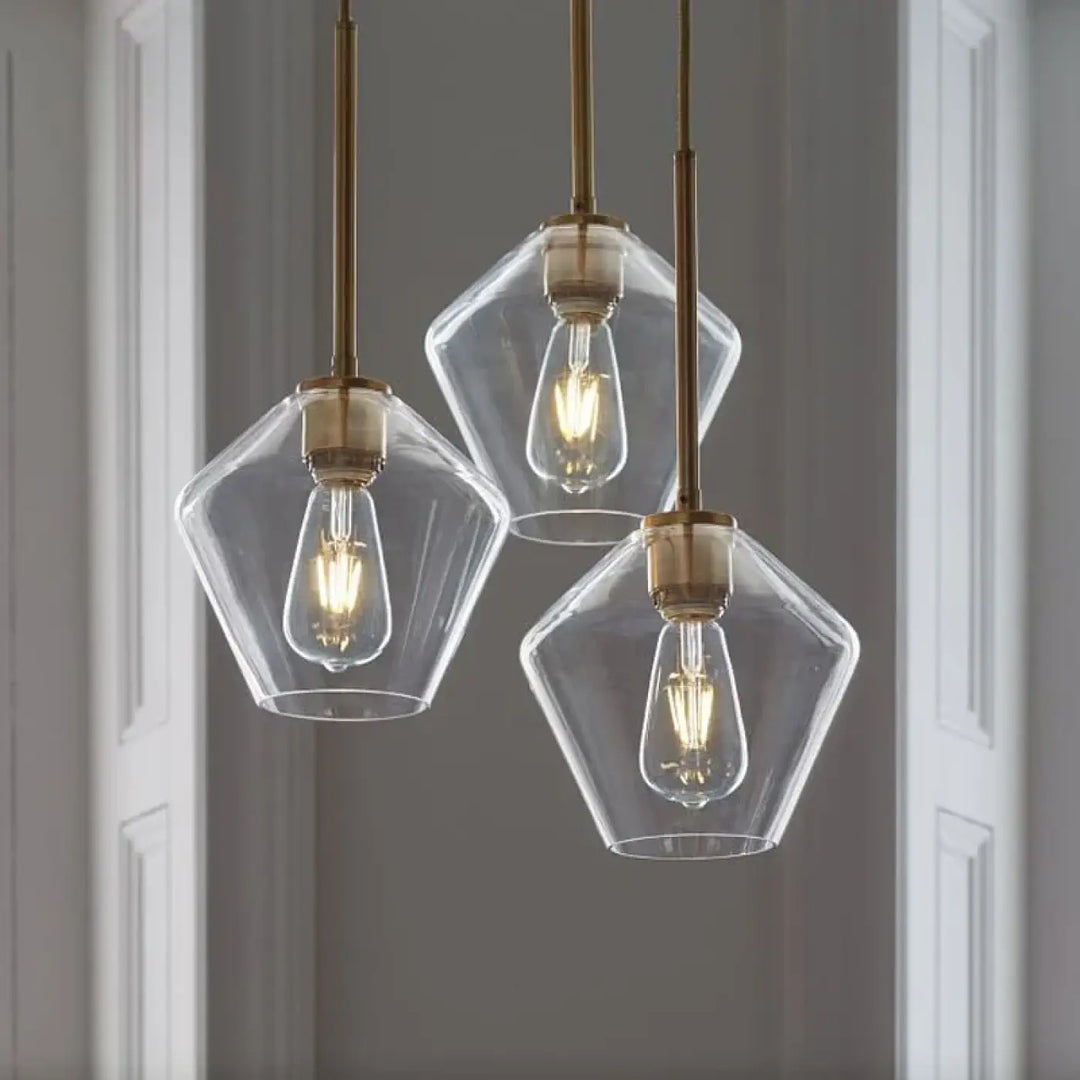 Suspension luminaire glazia avec verre transparent et métal doré en verre géométrique et ampoules à filament visible