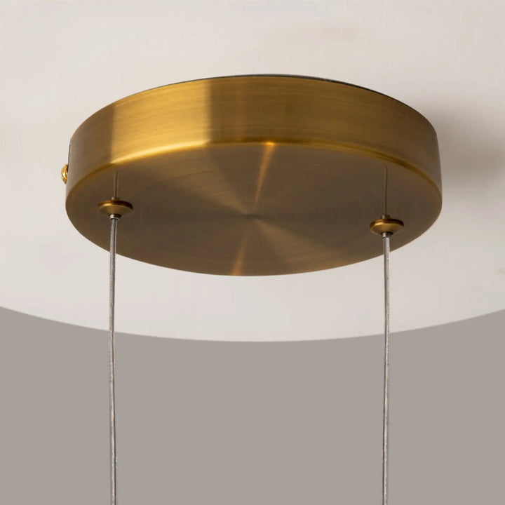 Suspension lunare led disque doré avec finition en laiton et deux câbles fins pour éclairage plafond moderne