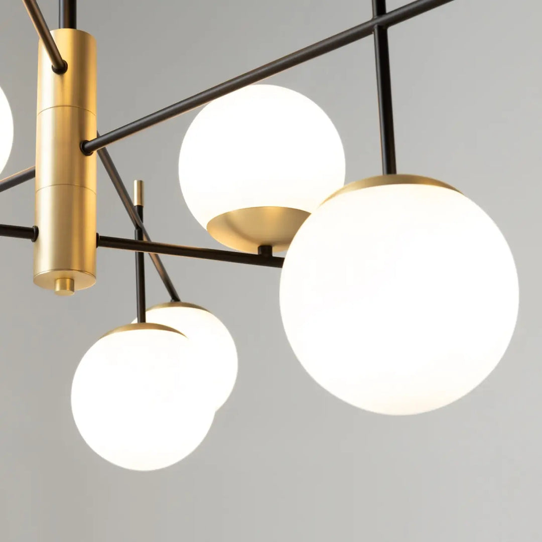 Suspension luminaire nostalgia xxl avec neuf globes en verre dépoli et colonne centrale en laiton brossé acier noir