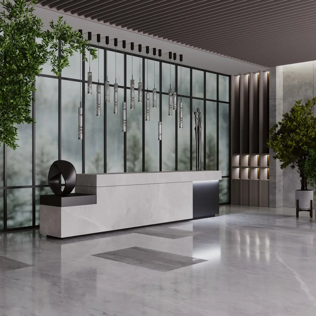 Modern white marble reception desk with sleek black accents featured under suspension ordo led verre teinté lighting tube