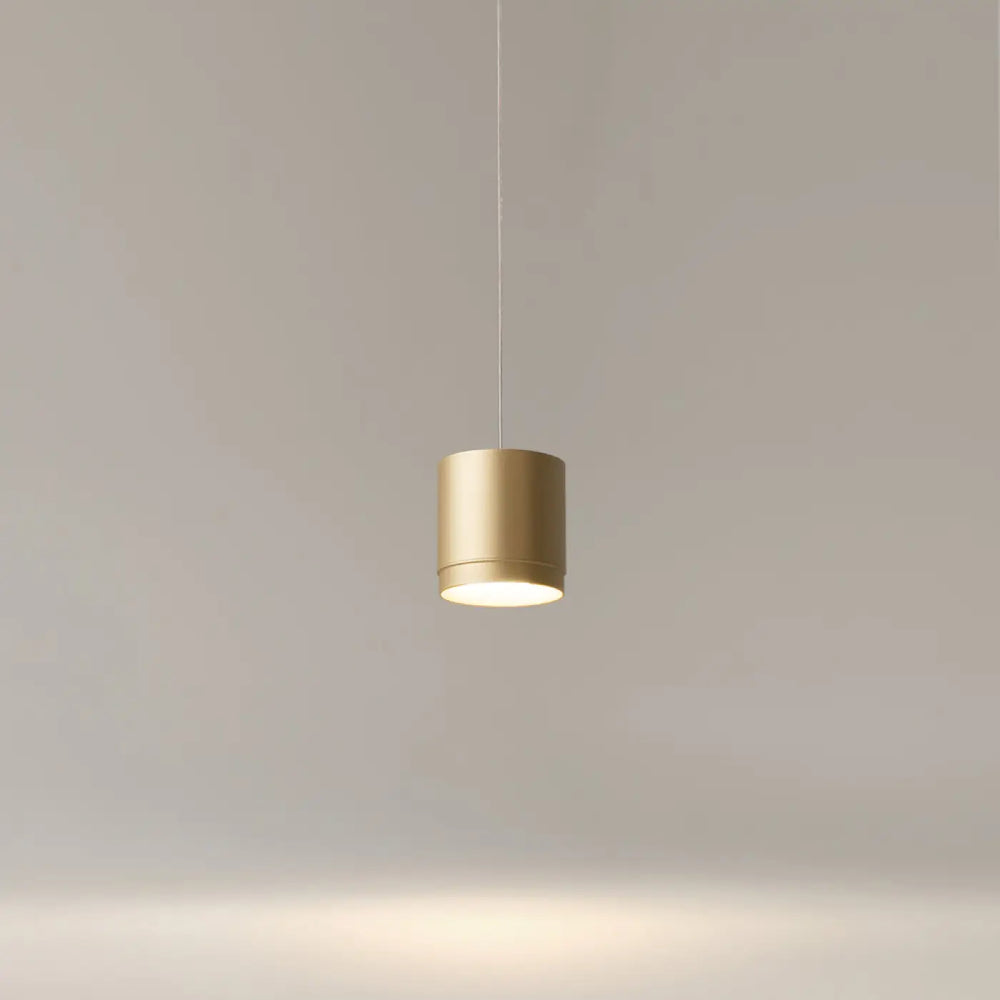 Suspension luminaire polar petit disque en or cylindrique avec design minimaliste et lumière ambiante douce