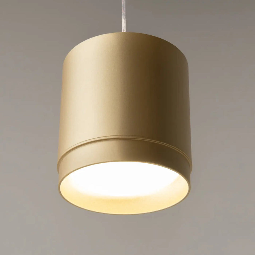 Suspension luminaire polar petit disque cylindrique élégant finition or mat avec lumière intérieure chaude