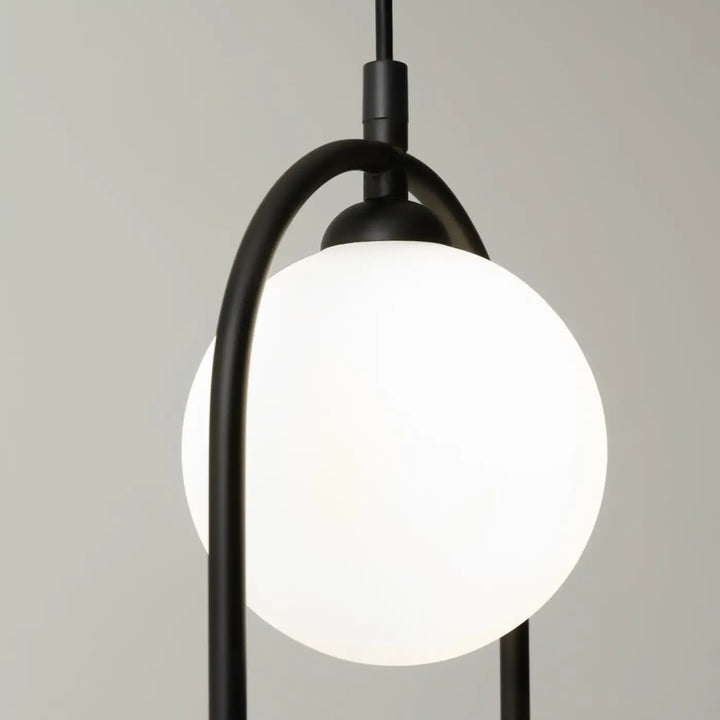 Suspension ring art déco en métal noir avec globe en verre givré blanc pour éclairage au-dessus d’un îlot
